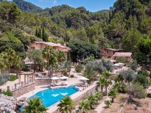 an aerial view of a resort with a swimming pool and mountains at Ratxó Retreat Hotel, member of Meliá Collection in Puigpunyent