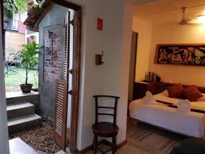 a bedroom with a bed and a bed and a chair at Highbury Colombo in Colombo