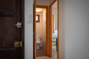 an open door to a bathroom with a toilet at AT137 Abadia in Torredembarra +18 photos