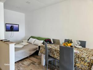 a room with a bed and a table with a couch at BAGLIO SUL MARE Letojanni Taormina in Letojanni