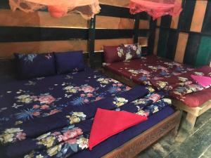 two beds sitting next to each other in a room at New Happy Elephant Bungalows 