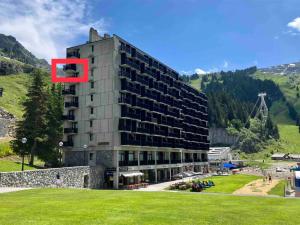 a large building with a red object in front of it at Superbe studio idéalement situé à Flaine Forum in Flaine