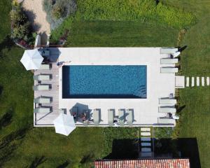 an aerial view of a building with a swimming pool at Relais Chiarene in Novello