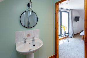 a bathroom with a sink and a mirror on the wall at Lochbroom Lodge in Ullapool