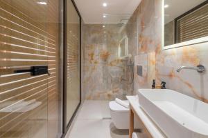 a bathroom with a shower and a sink and a toilet at The Wine Hotel in Rhodes Town