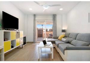a living room with a couch and a tv at Paraíso zahara in Zahara de los Atunes