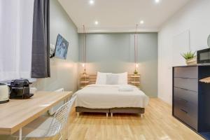 a bedroom with a bed and a desk at Lille Centre - Nice studio in Lille +40 photos