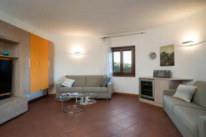 a living room with a couch and a tv at I Lecci 1 by Klodge in Olbia