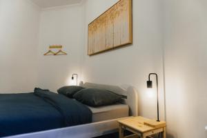 a bedroom with a bed and a wooden table at Lighthouse Hostel & Rooms in Rīga