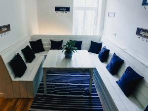 a couch with a potted plant on it in a room at Lighthouse Hostel & Rooms in Riga