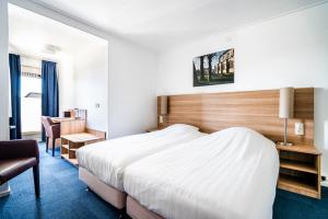 Een bed of bedden in een kamer bij Hotel Hulst