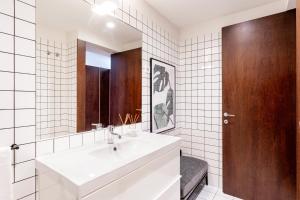 a bathroom with a white sink and a mirror at VIVA Serralves Patio in Porto +39 photos