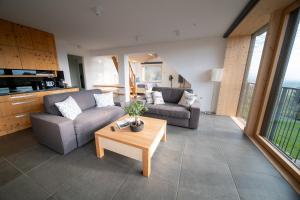 a living room with two couches and a table at eco boutique hotel AMS Beagle in Bled