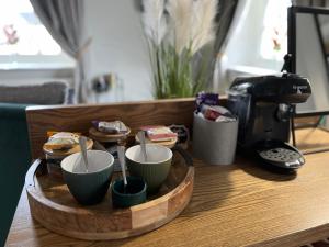 a wooden tray with four cups on a table at Devonshire Arms in Hartington
