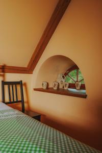 a bedroom with a bed and a window and a shelf at Bělský Dvůr in Bělý