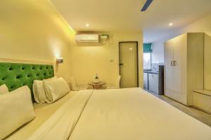 A bed or beds in a room at Baga Galaxy