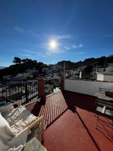 a balcony with a bed and a view of a city at Casa Rural con vistas espectaculares in Montejaque