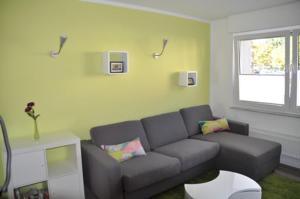 a living room with a couch and a window at Zuhause auf Zeit Bielefeld in Bielefeld