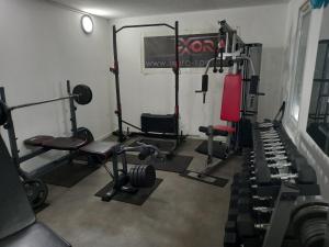 a gym with several tread machines and a red chair at hôtel QUICK Palace Tours Nord in Tours