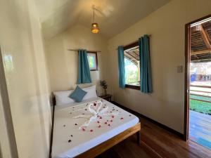 a bedroom with a bed with flowers on it at Lunazul Guesthouse in San Vicente