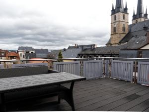 a wooden deck with a bench and a view of a city at ThüringenApartments Boulevard XXL 5-7 Personen in Saalfeld