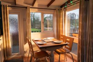 a table and chairs in a room with a window at Bunny Lodge 30 - Riverside in Builth Wells