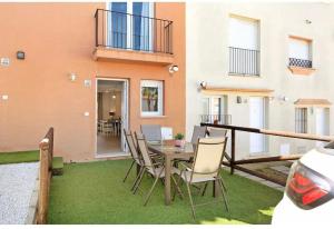 a patio with a table and chairs and a building at Paraíso zahara in Zahara de los Atunes