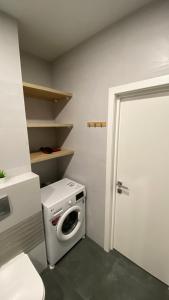 a laundry room with a washing machine and a door at FlatService Просторі апартаменти в сучасному ЖК Parkland in Kyiv
