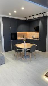 a kitchen with a table and chairs in a room at FlatService Просторі апартаменти в сучасному ЖК Parkland in Kyiv