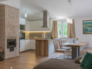 a kitchen and living room with a table and a stove at Villa Drazana in Imotski