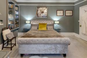 a bedroom with a large bed and two lamps at The Georgian Villa in Ross on Wye