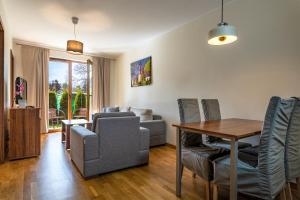 ein Wohnzimmer mit Tisch und Couch in der Unterkunft Apartamenty Rozewie in Jastrzębia Góra