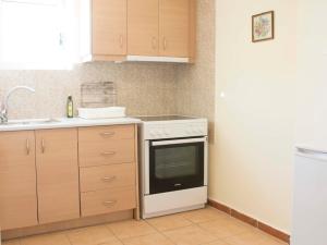 a kitchen with a white stove and a sink at Poliana Estate Studios in Kotrónion +1 photo