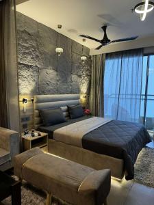 a bedroom with a large bed and a large window at The Opulence Suite 41st Floor City View in Noida