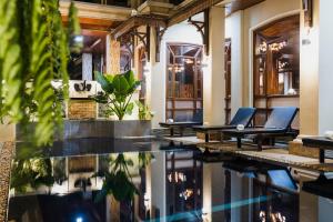 a lobby with chairs and a swimming pool at Pierre Hotel in Siem Reap
