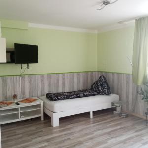 a living room with a couch and a flat screen tv at Gäste Monteurzimmer Haus Südstadt in Solingen