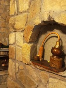 a stone wall with a brick oven with a kettle on it at Anneta s StudioBear s Path in Sklíthron