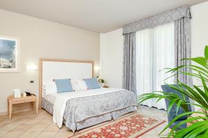 Rúm í herbergi á Park Hotel Argento