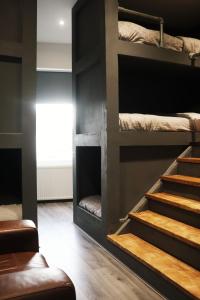 a room with four bunk beds and a staircase at The Anfield View in Liverpool