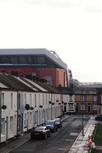 a parking lot with cars parked in front of a building at The Anfield View in Liverpool