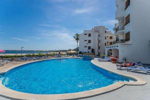 a large swimming pool with chairs and a building at E428 Anglada 54 by Mallorca Villa Selection in Alcudia