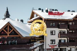 a building with a large clock on the side of it at Ski-Inn RukaVillage in Ruka