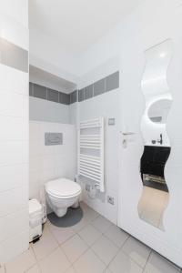 a white bathroom with a toilet and a sink at Studio cosy vue sur le musée - Paris 5 - 2P in Paris