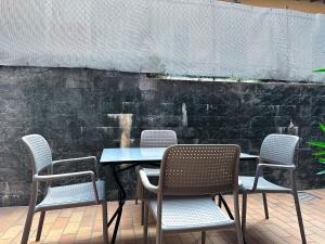 mesa con 4 sillas, mesa y pared en Paloma center town apartment en Bellagio