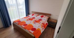 a bedroom with a bed with flowers on it at Apartmány Semily in Semily