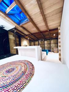 a white bed in a room with a wooden ceiling at The Hidden Gem Of Bordeaux in Lormont
