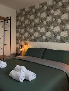 two towels sitting on a bed in a bedroom at AtticoCinque in Bari +62 photos