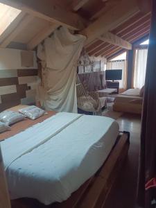 a bedroom with a bed and a hammock in a room at Chalet des secrets in Lyaud