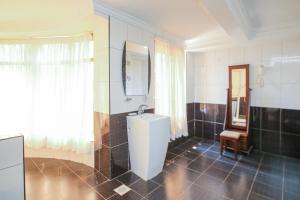 y baño con aseo, lavabo y espejo. en Eldon Apartments & Suites, en Nairobi