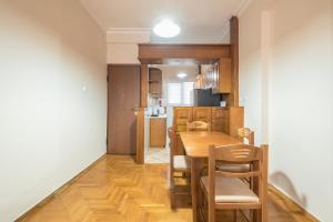 a kitchen and dining room with a table and chairs at Sofihome Ampelokipi Station in Athens